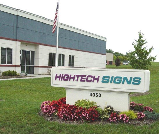 The Hightech Signs building at 4050 Thunderbird Lane, with the company's own monument sign on the lawn in front of it